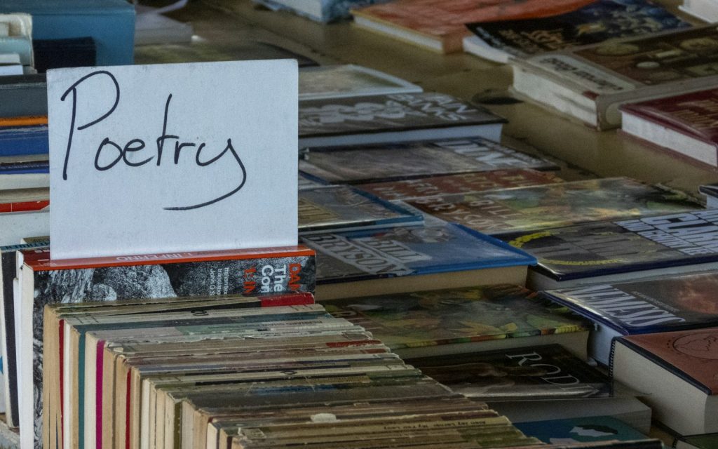 Assorted poetry books displayed on a shelf