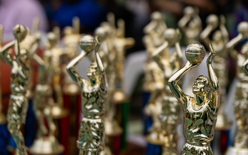 Row of golden award trophies with a softly blurred background