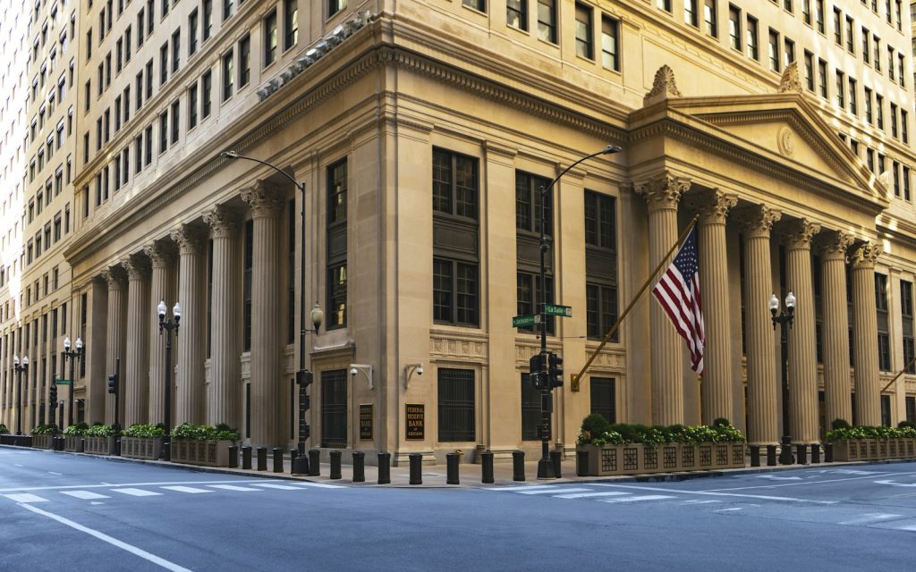 Neoclassical government building with stone columns and a flag