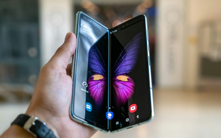 A person holding a black smartphone