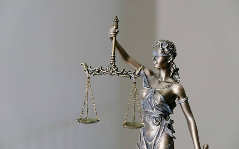 Statue of Lady Justice holding scales and a sword