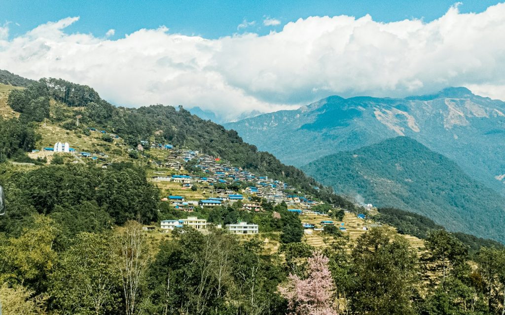 Houses scattered across a steep Himalayan mountainside