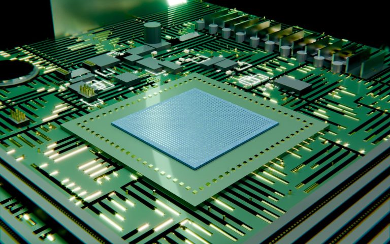 A green circuit board with a central microchip
