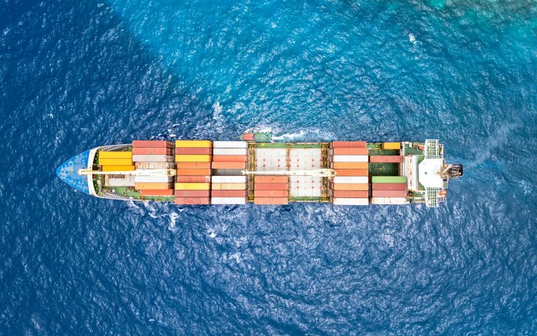 Aerial view of a cargo ship crossing open ocean