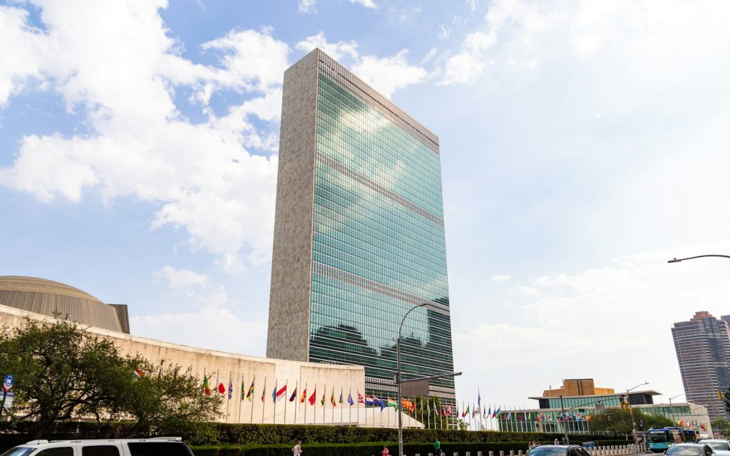 United Nations headquarters building in New York with member flags flying