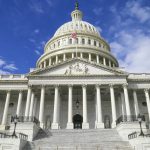 The US Capitol building with its white dome against a blue sky
